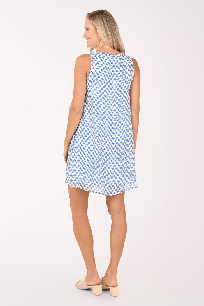 Woman wearing a blue patterned dress on a white background