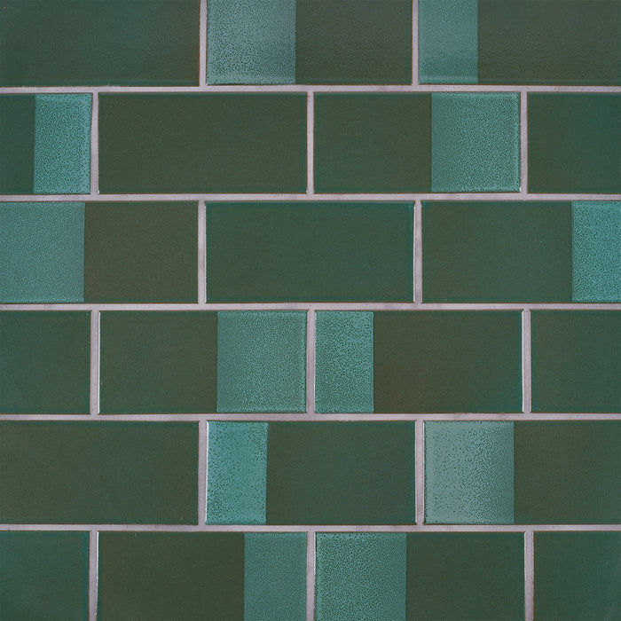 Caption: Dual Glaze 3x6 in DG18 Geyser Green Blend Rectangles. Natural Grey grout by Custom Building Products.
