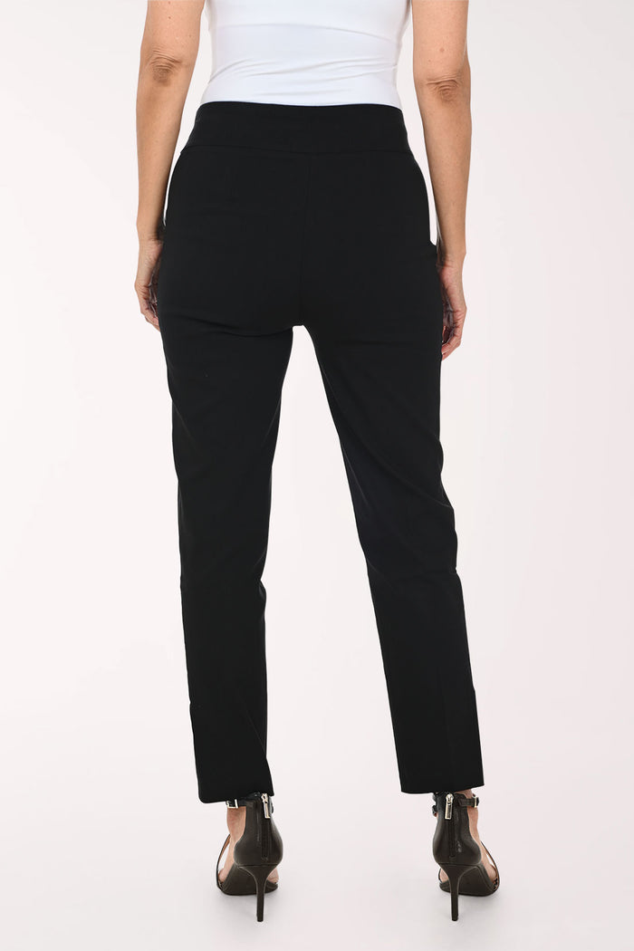 A model wearing black slim-fit ankle-length pants with decorative silver buttons on the lower hem, paired with a white top and black strappy heels, against a plain white studio background.