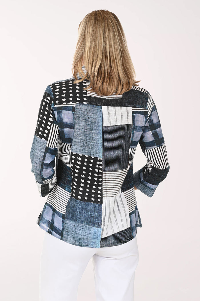 Woman wearing a patchwork shirt with a white background