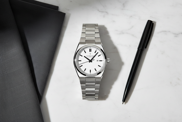 Nordgreen Succession 41mm White Dial Black Indices watch flat lay on white marble with charcoal linen