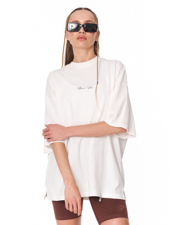 Oversized Monarch Loop White T-Shirt paired with sunglasses and shorts