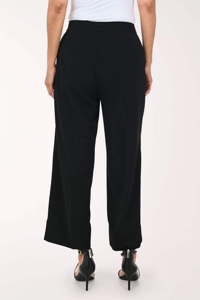 Black wide-leg cropped pants with a drawstring waist, shown on a model wearing black strappy heels against a plain light background.