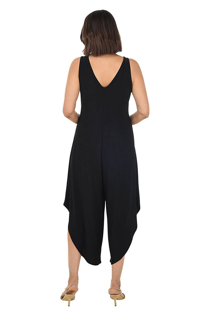 Woman wearing a black sleeveless jumpsuit on a white background