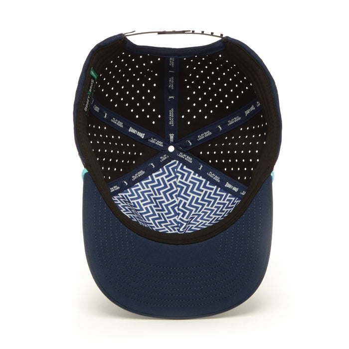 A look inside the 3 Off The Tee - Performance Golf Rope Hat - Snapback reveals dark blue perforated panels, a zigzag-patterned sweatband, branded inner taping, and a stitched brim for a clean, geometric style in performance material.
