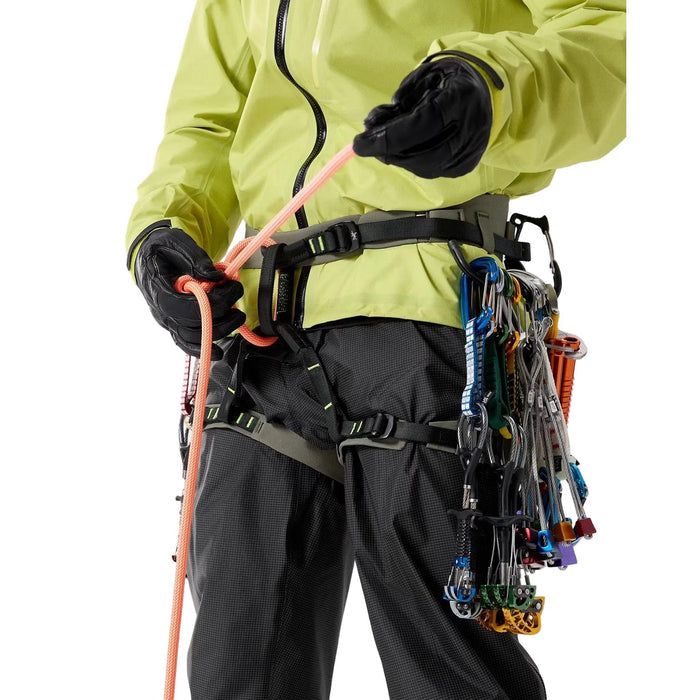 Person wearing Arcteryx AR-395a  climbing harness with ropes and equipment on a plain background