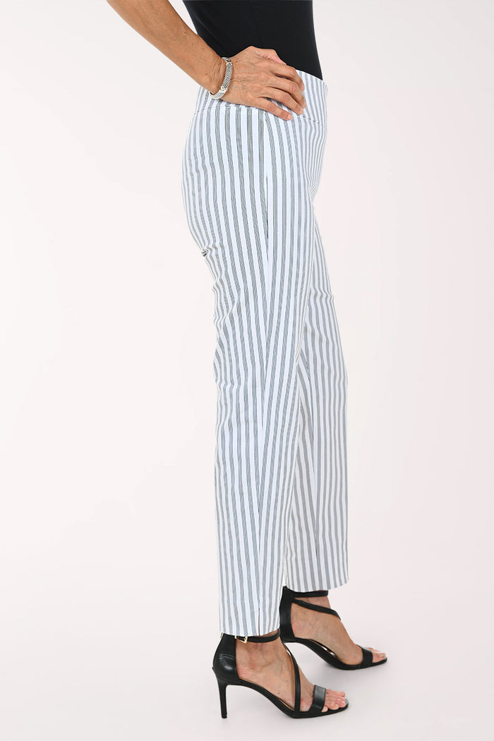 A model wearing light blue and white vertically striped cropped trousers, paired with a black top and black strappy high-heeled sandals, against a plain white studio background.