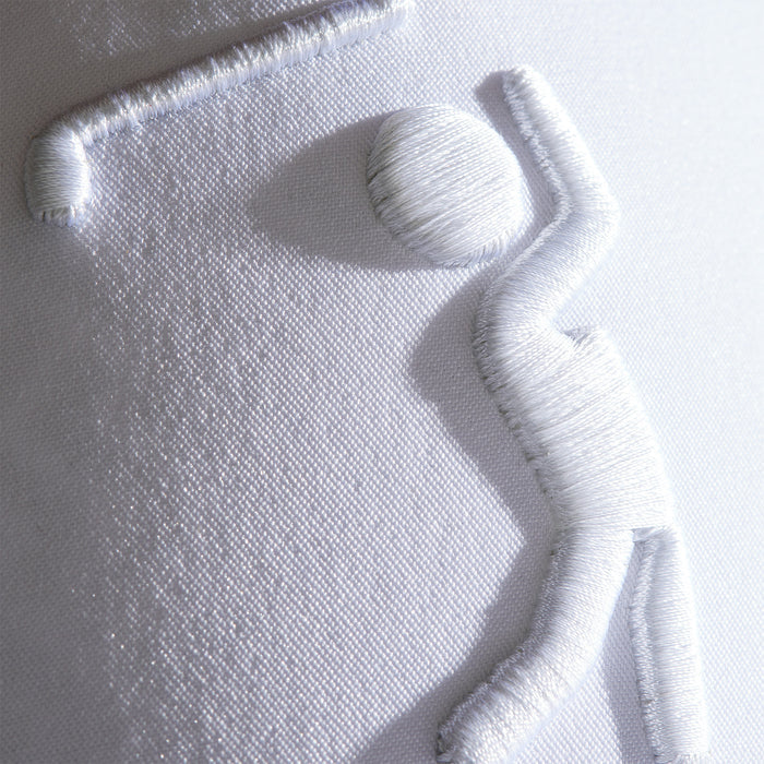 Close-up of the Bogeyman - White/White Performance Golf Hat, featuring a white embroidered golfer on textured, sweat stain resistant fabric. The raised stitching adds a 3D effect, while the snapback ensures lasting style and comfort.