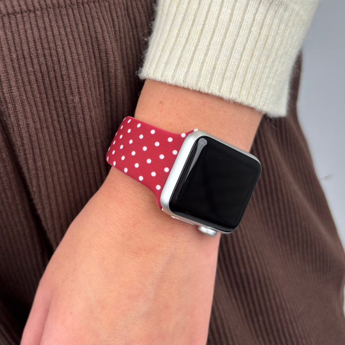 Coconut Lane burgundy polka dot Apple Watch strap worn on a wrist.