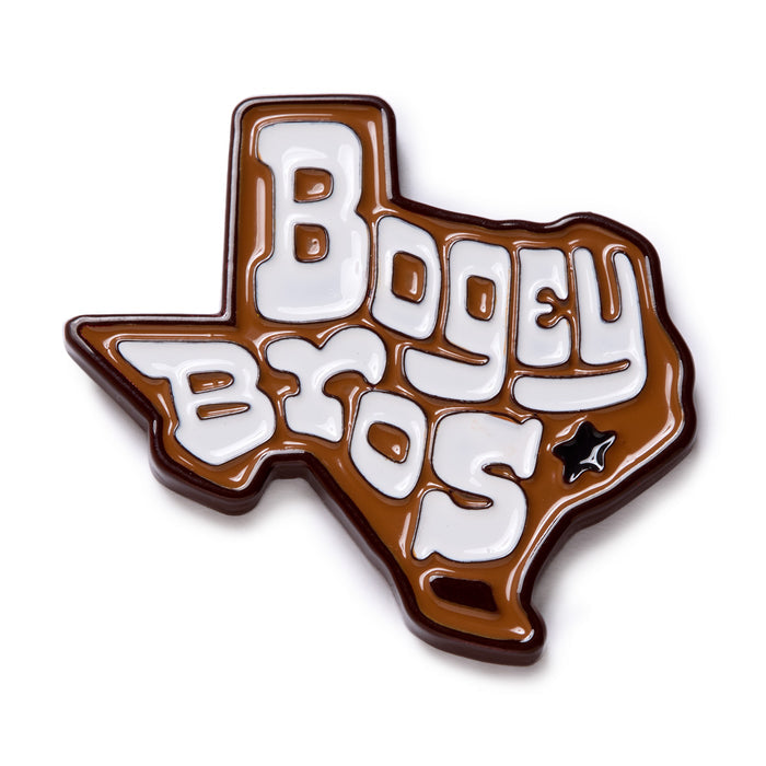 A shiny brown pin shaped like Texas with bold white lettering that reads BOGEY BYOS. Theres a small black star outline inside the lower right side of the state.