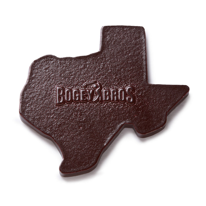 A dark brown object shaped like Texas, embossed with the text “BOGEY BROS” and a golfer silhouette swinging a club. The texture appears slightly rough, similar to leather or molded plastic.