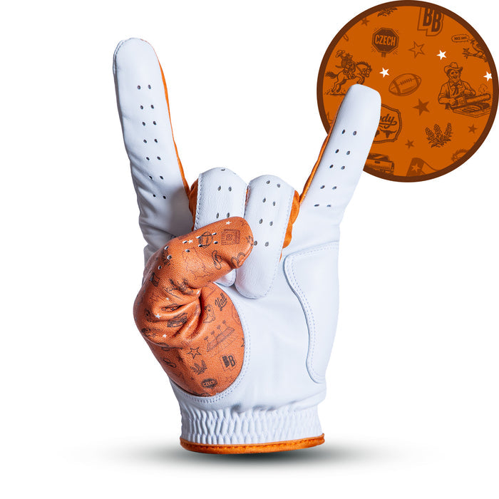 A white glove with orange trim makes a “rock on” hand gesture. The fingers and thumb display orange patterns with various icons and symbols, shown enlarged in a circle at the top right. The background is white and shadowed below the glove.