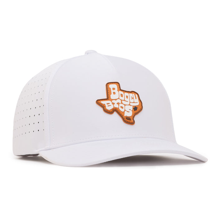 A white baseball cap with a flat brim. On the front, theres a brown Texas-shaped patch with Boggy Bros in white, stylized letters. The sides feature small ventilation holes. The cap is shown on a plain white background.