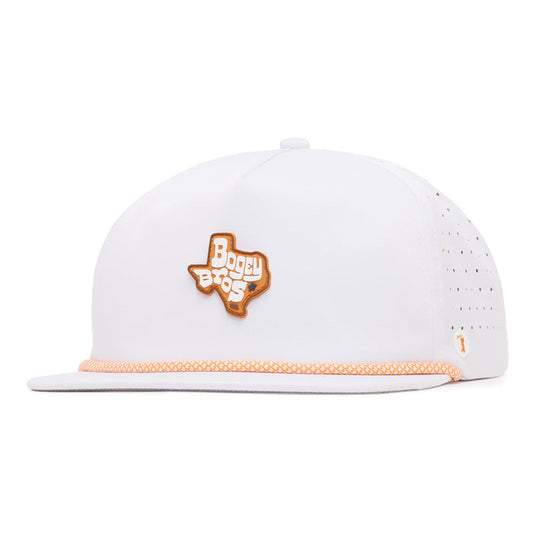 A white flat-brim cap with perforated sides, orange patterned trim on the brim, and an orange outline patch of Texas on the front with Boggy Bros in white and orange letters. Small orange logo on the left side near the brim.