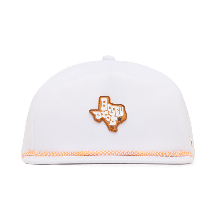 A white baseball cap seen from the front, featuring an orange patch in the shape of Texas with the words “Bogey Bros” embroidered inside it. The cap also has orange stitched detailing along the front edge of the brim.