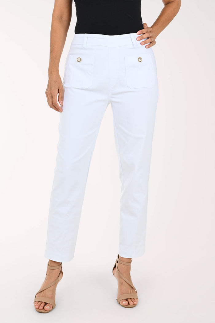White cropped ankle-length pants with front patch pockets and decorative gold-tone buttons, shown on a model wearing a black top and tan heeled sandals against a light studio background.
