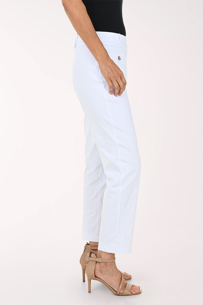White cropped ankle-length pants with front patch pockets and decorative gold-tone buttons, shown on a model wearing a black top and tan heeled sandals against a light studio background.