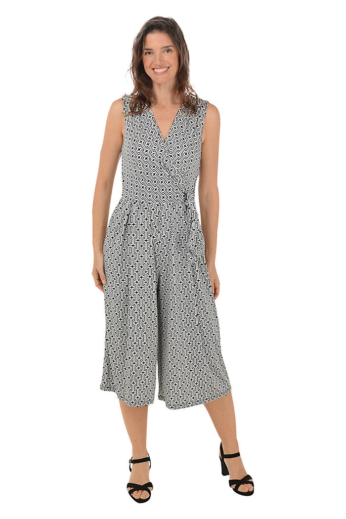 Woman wearing a patterned jumpsuit on a white background