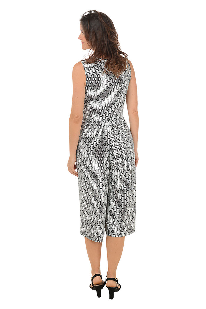 Woman wearing a patterned jumpsuit on a white background