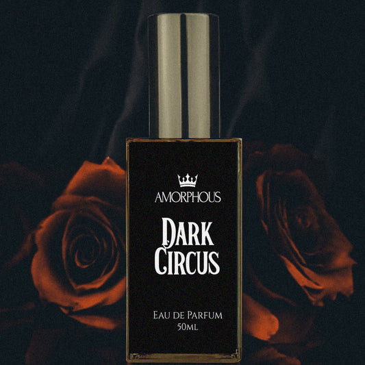 Amorphous Dark Circus Eau de Parfum bottle with red roses in the background