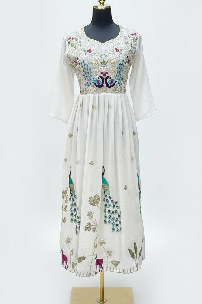 Kurti Connection USA off-white Anarkali dress with vibrant peacock embroidery, V-neckline, and pleated skirt.