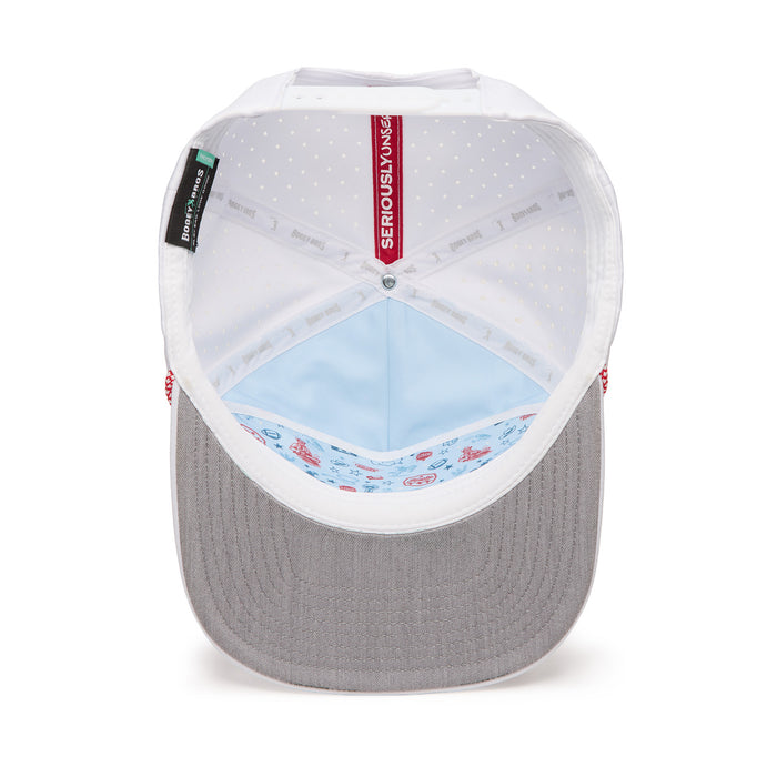 View of the inside of a baseball cap, showing a grey brim, white mesh-like lining with dots, light blue inner fabric with playful illustrated patterns, and labels including “SERIOUSLY VENTED” sewn into the headband area.
