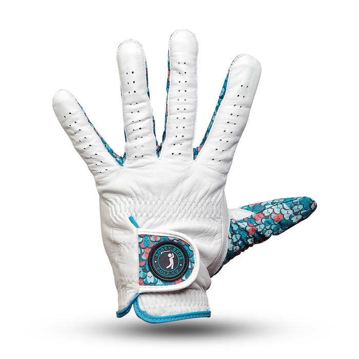 The Eyes Up Here - The 305 - Glove is a white Cabretta leather golf glove with teal and pink scale accents on the inside thumb and wrist, reinforced seams, ventilation holes, and a golfer silhouette patch on its adjustable wrist strap.