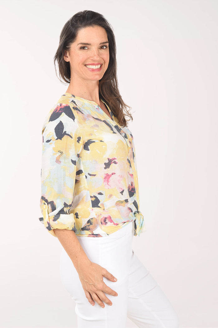 Woman wearing a floral blouse with a white background