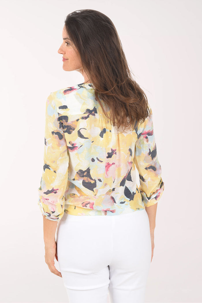 Woman wearing a floral blouse with a white background