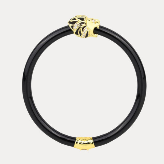 a black and gold bracelet with a lion head