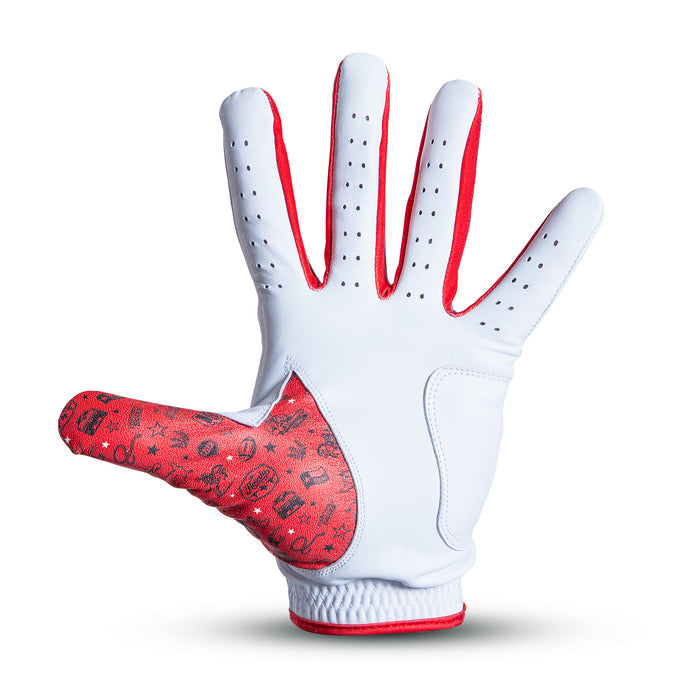 A white glove with red trim and ventilation holes is shown palm up. The thumb area is red with playful black patterns, including faces, stars, and symbols. The wrist has a textured, elastic band. The background is plain white with a subtle shadow beneath the glove.