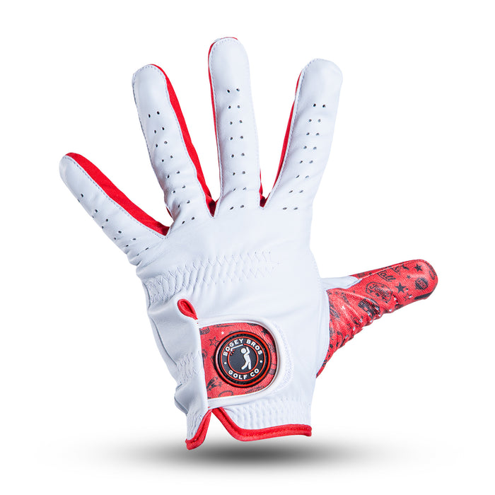 A white golf glove with red trim and inner thumb, displayed palm up. The palm features a circular logo, ventilation holes on the fingers, and visible gathered stitching at the wrist. The background is plain white with a soft shadow below the glove.