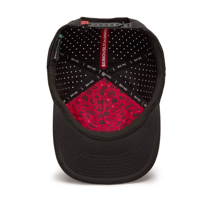 Black baseball cap shown from above, revealing its interior. The inside is black with small white dots and black tape labeled SERIOUSLY UNSERIOUS. The inner front panel is red with black doodles, and the adjustable back is visible.