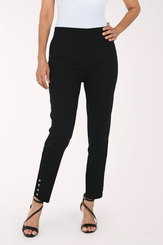 A model wearing black slim-fit ankle-length pants with decorative silver buttons on the lower hem, paired with a white top and black strappy heels, against a plain white studio background.