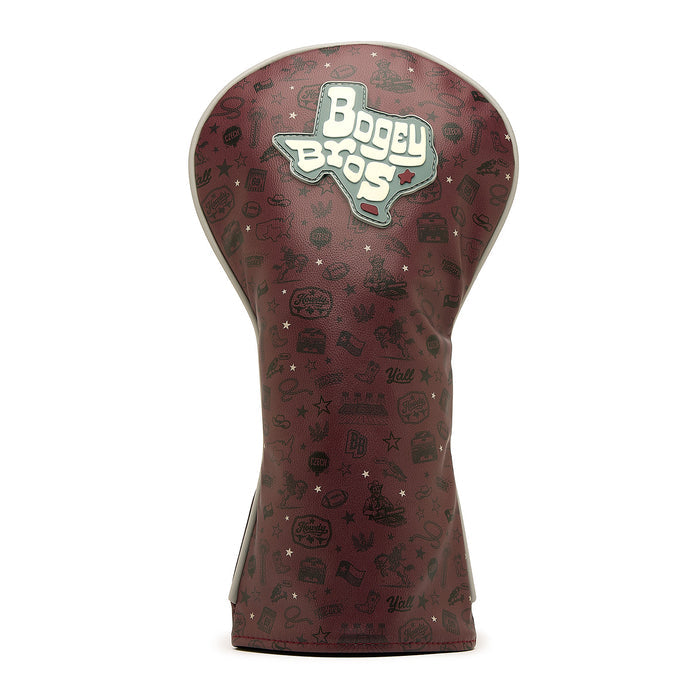 The Hard Corps - Driver Headcover is crafted from premium maroon PU leather and showcases an embroidered Texas outline with Bogey Bros text, complemented by small black golf and Texas-themed icons scattered across its smooth surface. Standing upright on a white background, this headcover combines style and durability to elevate your golf gear.