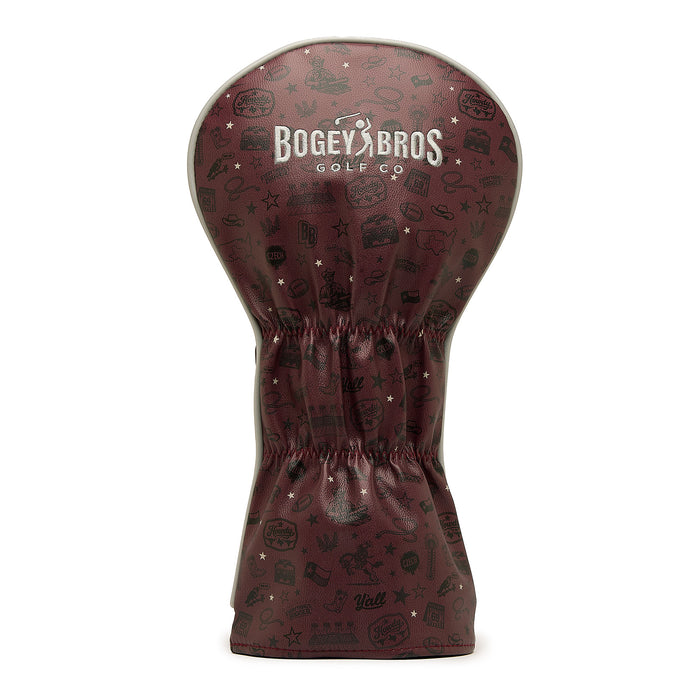 Introducing the Hard Corps - Driver Headcover: a maroon, premium PU leather driver head cover with a cinched middle. It features the white BOGEY BROS GOLF CO logo and an all-over design of assorted black, doodle-style golf images and phrases. The embroidered detailing enhances both durability and sophistication, making it a standout addition to your golf gear.