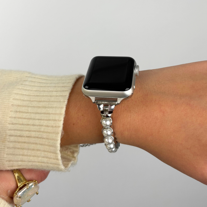 Silver Isla Pearl Apple Watch strap with pearl details worn on a smartwatch.