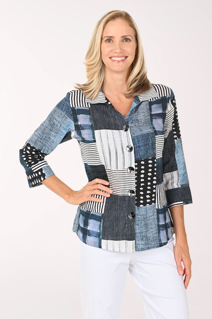 Woman wearing a patchwork shirt with a white background