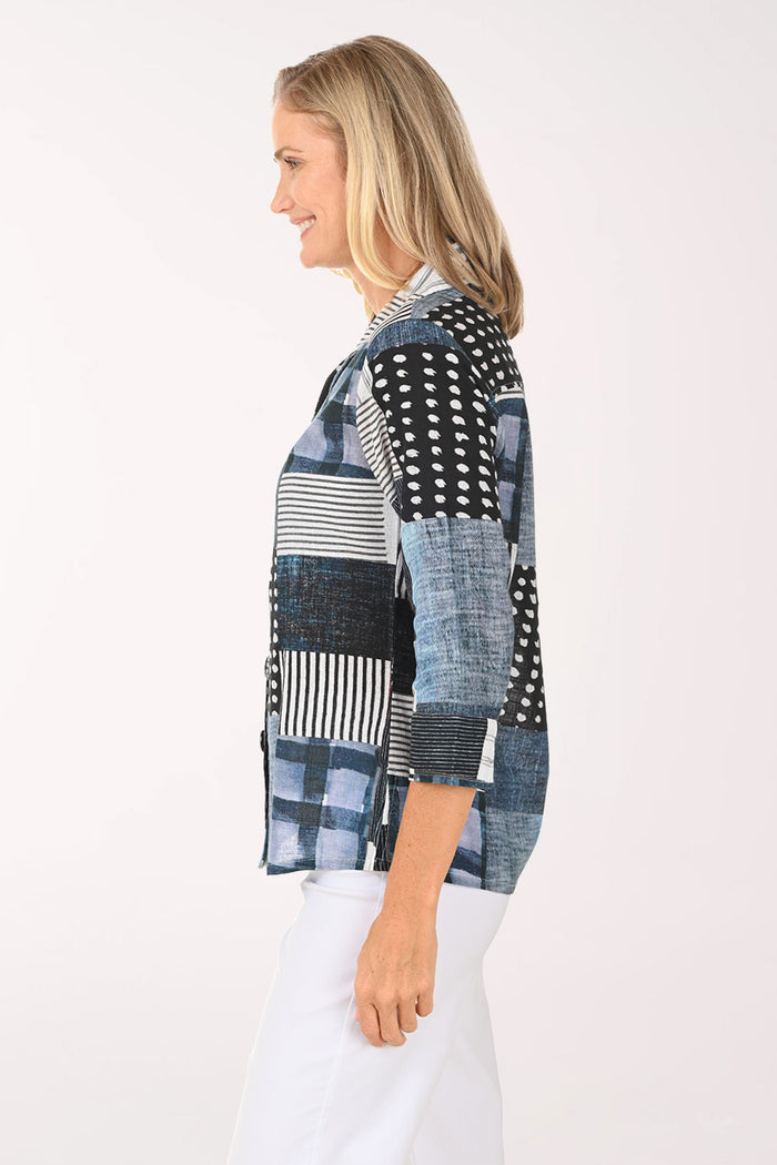 Woman wearing a patchwork shirt with a white background