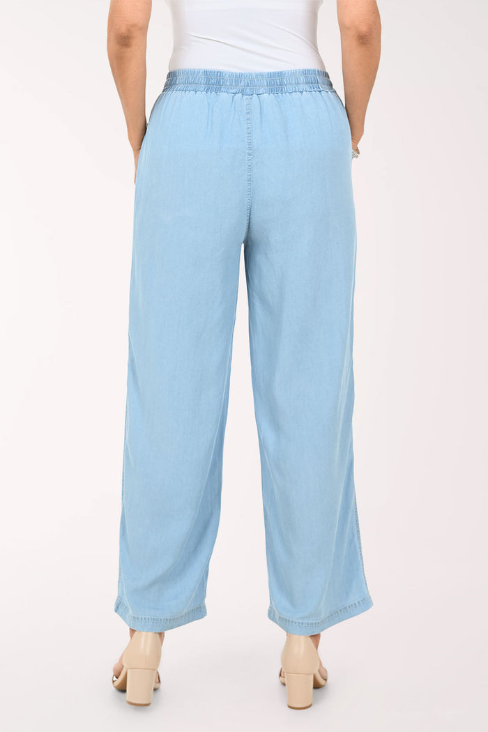 Light blue wide-leg cropped pants with an elastic drawstring waist and large front patch pockets, shown on a model against a plain light background.