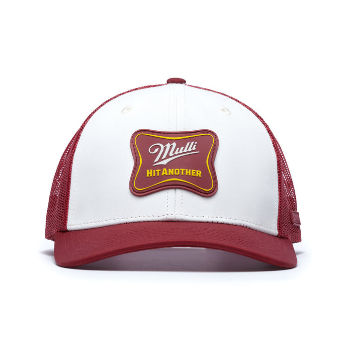 The Mulli Hit Another Mesh Trucker Hat features a red bill, white front panel with a "Mulli" patch and "HIT ANOTHER" in yellow on a red badge. It has a snapback closure and red mesh back for breathable comfort.