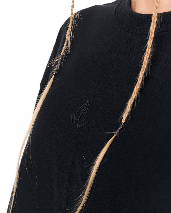 Woman wearing Namaste oversized black crop-top T-shirt front view