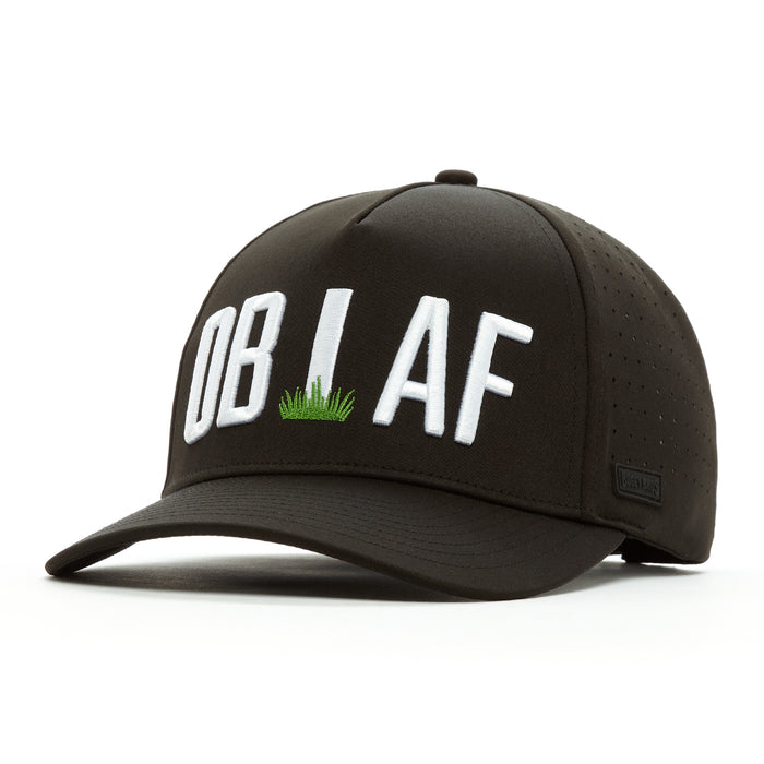 The OB AF - Performance Golf Hat - Snapback is a black cap with “OB I AF” in bold white letters, the “I” as a golf tee in green grass. Made from performance material, it has a curved brim, sweat-resistant finish, and side perforations.