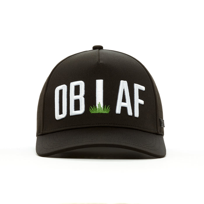 The OB AF - Performance Golf Hat - Snapback is a black cap featuring large white “OB AF” embroidery with a grass “L” detail, made from sweat stain resistant performance material and shown on a white background.