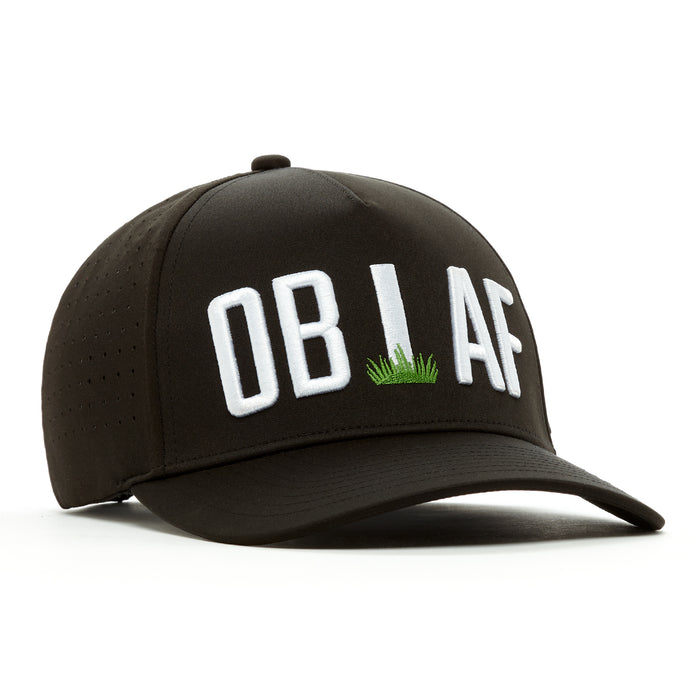 The OB AF - Performance Golf Hat - Snapback is a black cap with "OB I AF" in bold white letters, the "I" as a white post with grass. Made from sweat stain resistant material, it features a curved brim, snapback closure, and ventilated side panels.