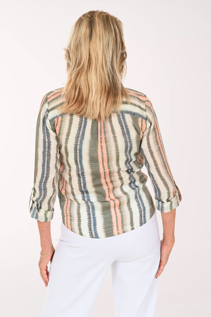 Woman wearing a green striped button down blouse