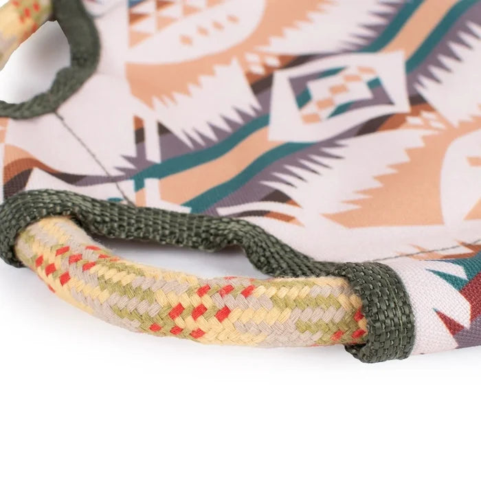 Close-up of a patterned dog toy with a braided handle on a white background