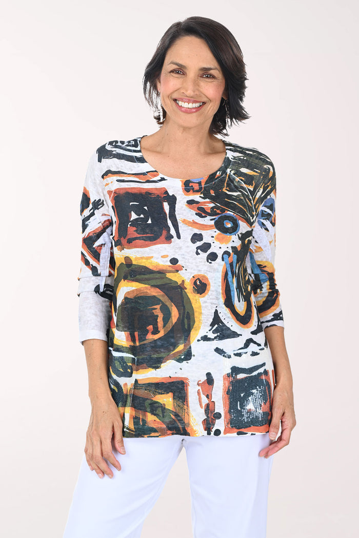 Woman wearing a colorful abstract patterned top against a white background