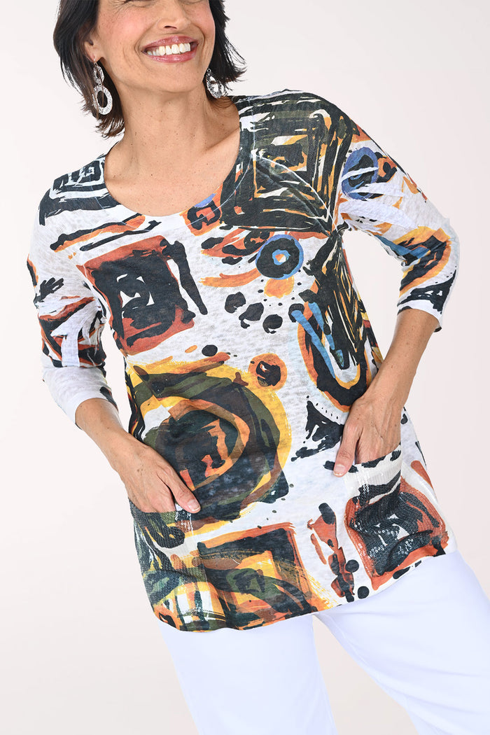 Woman wearing a colorful abstract patterned top against a white background