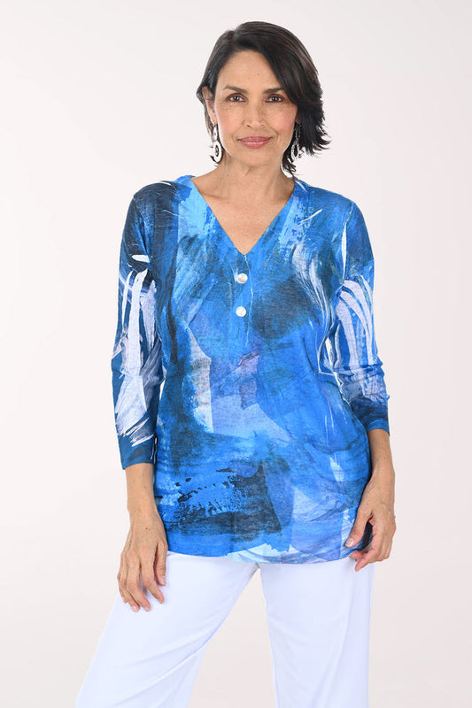 Woman wearing a blue abstract patterned top on a white background